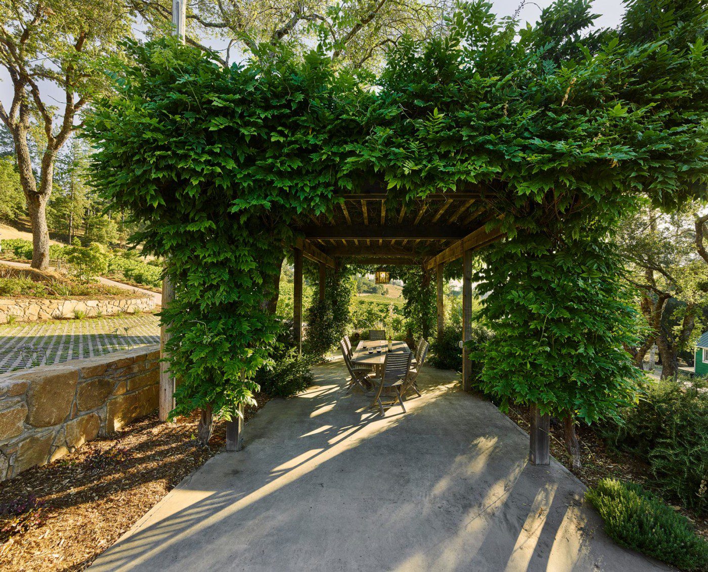 wine country shaded outdoor patio seating area with greenery