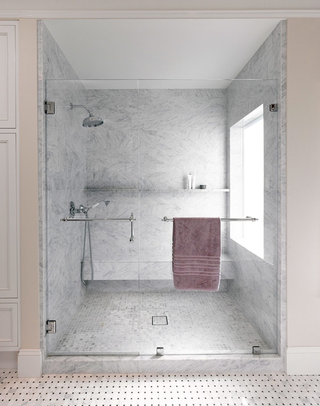 modern shower with Carrera marble subway tiles