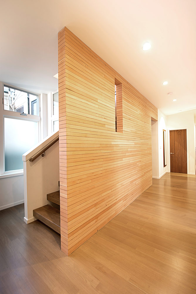 large wood wall with cut outs next to staircase in noe valley