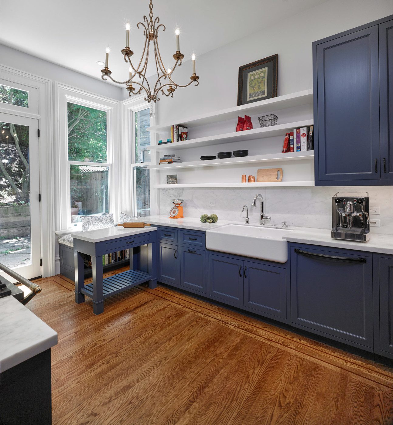 open plan kitchen blue cabinets with victorian chandelier
