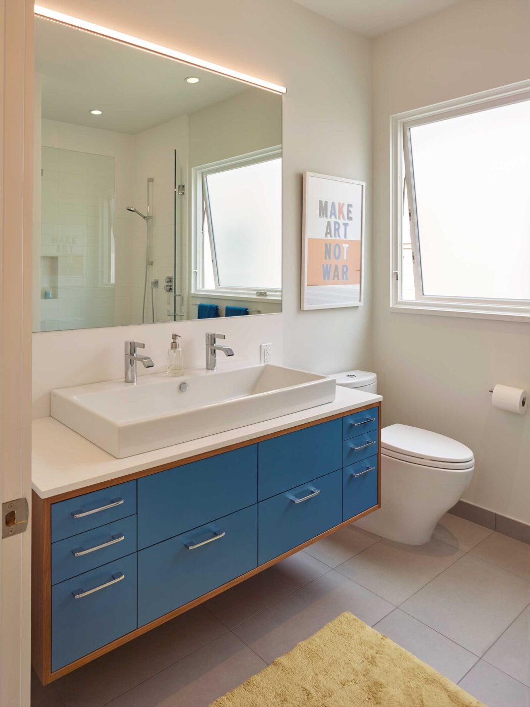 noe valley ca remodel bathroom with double sink with blue vanity, gray tile