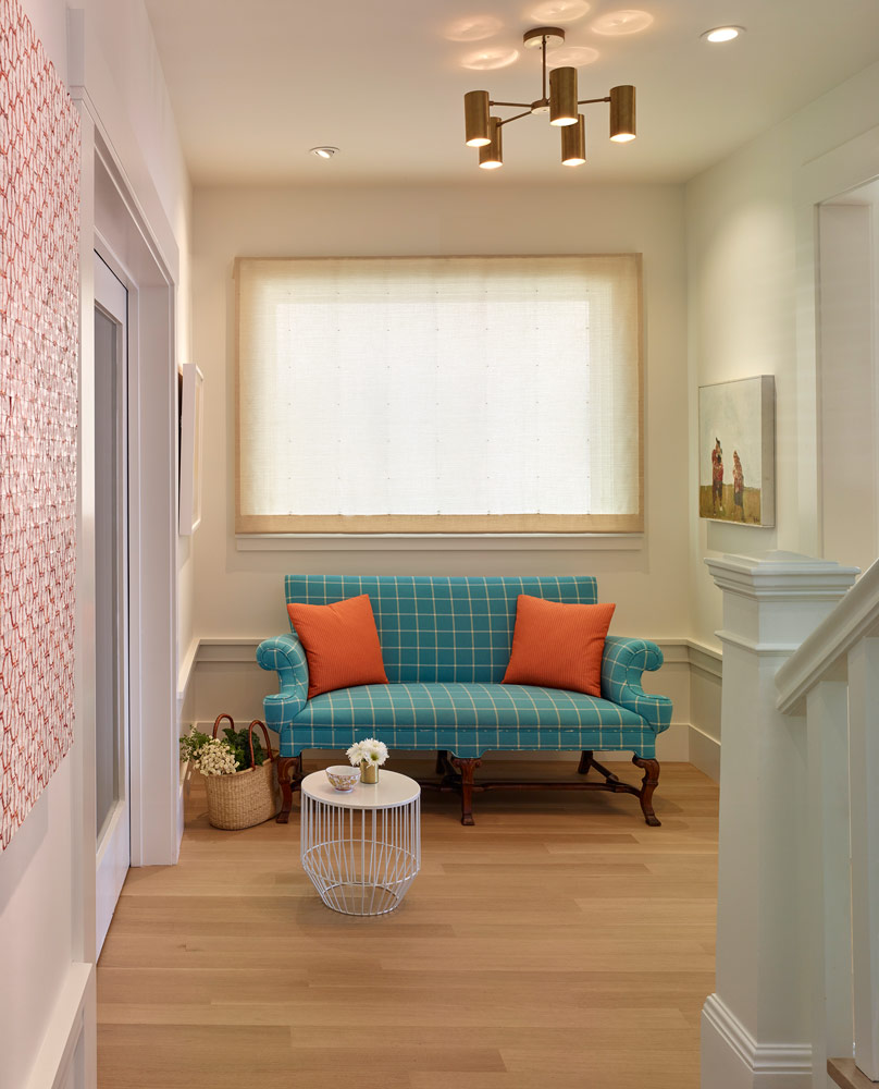 turquoise couch with orange pillows and modern ceiling fixtures remodel