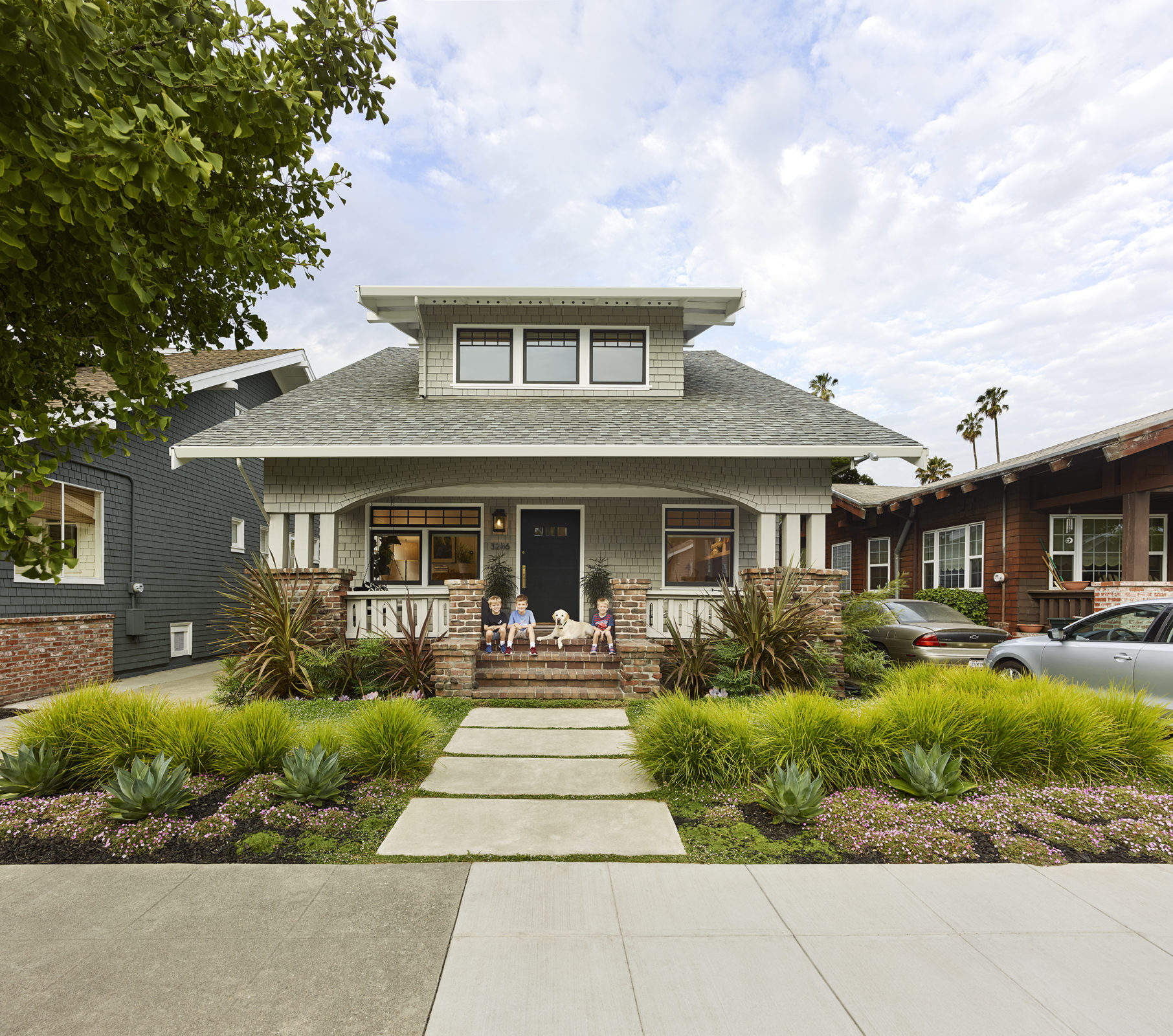 Alameda Family Home with children and dog sitting on front entry steps