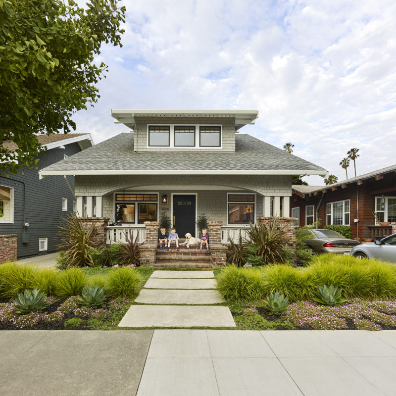 Alameda Family Home with children and dog sitting on front entry steps