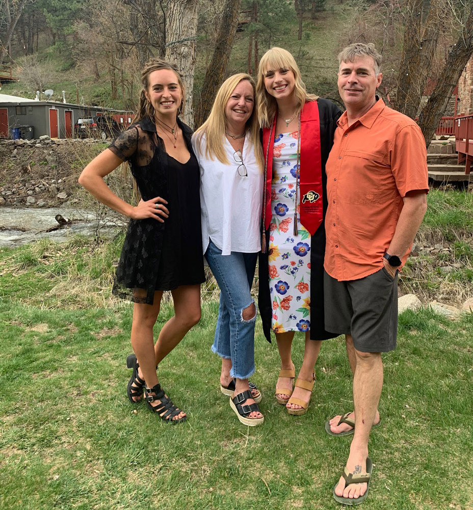 Brad with wife and daughters outside