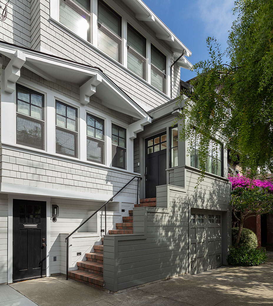 San Francisco craftsman renovation with modern grey stairway white house and black front door