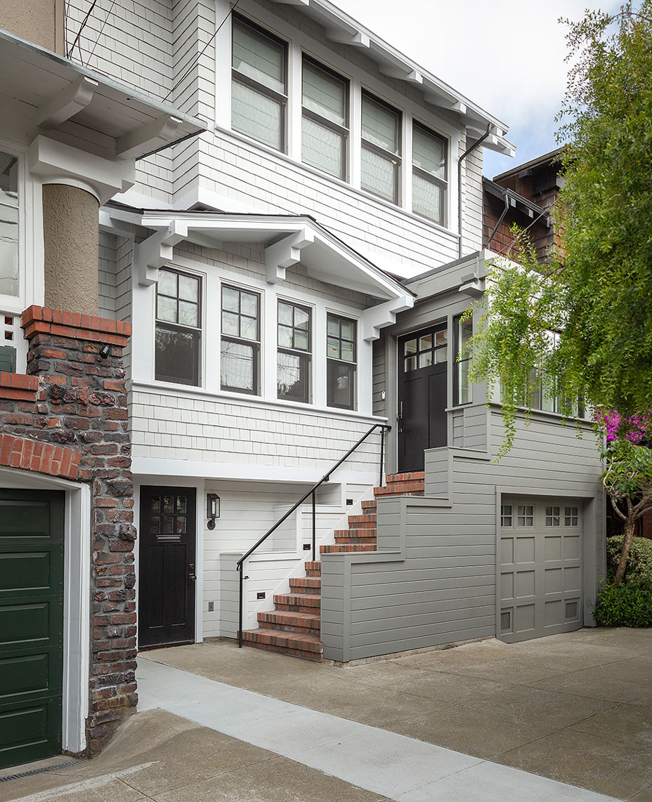 San Francisco craftsman renovation with modern grey stairway white house and black front door