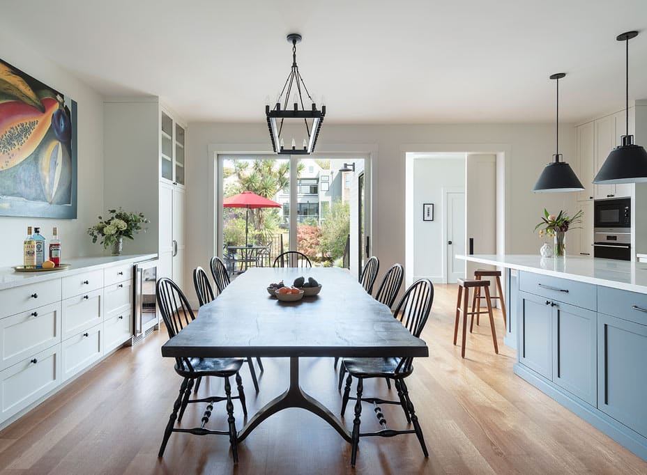 View of backyard from modern open plan kitchen and dining area in San Francisco renovation