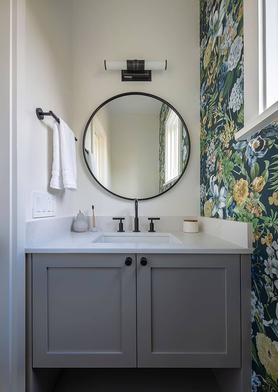 Modern powder room with floral wallpaper and black hardware in San Francisco renovation