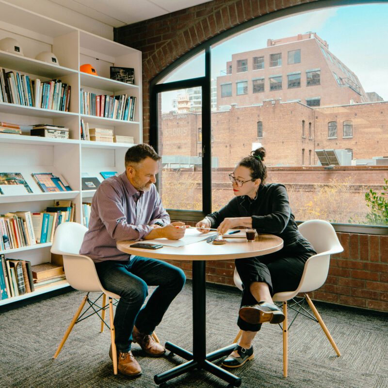 man and woman at round table working