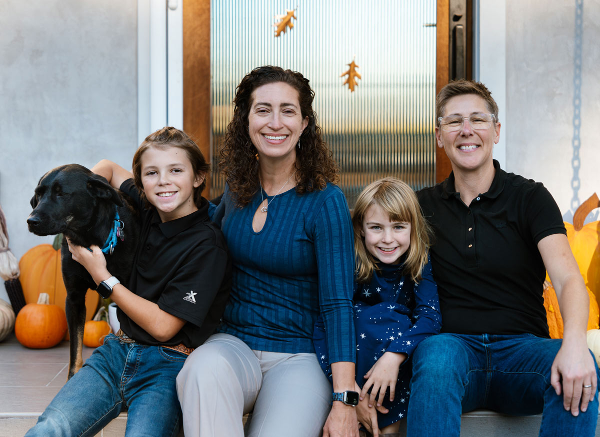 Kate and Tanya with family at front door