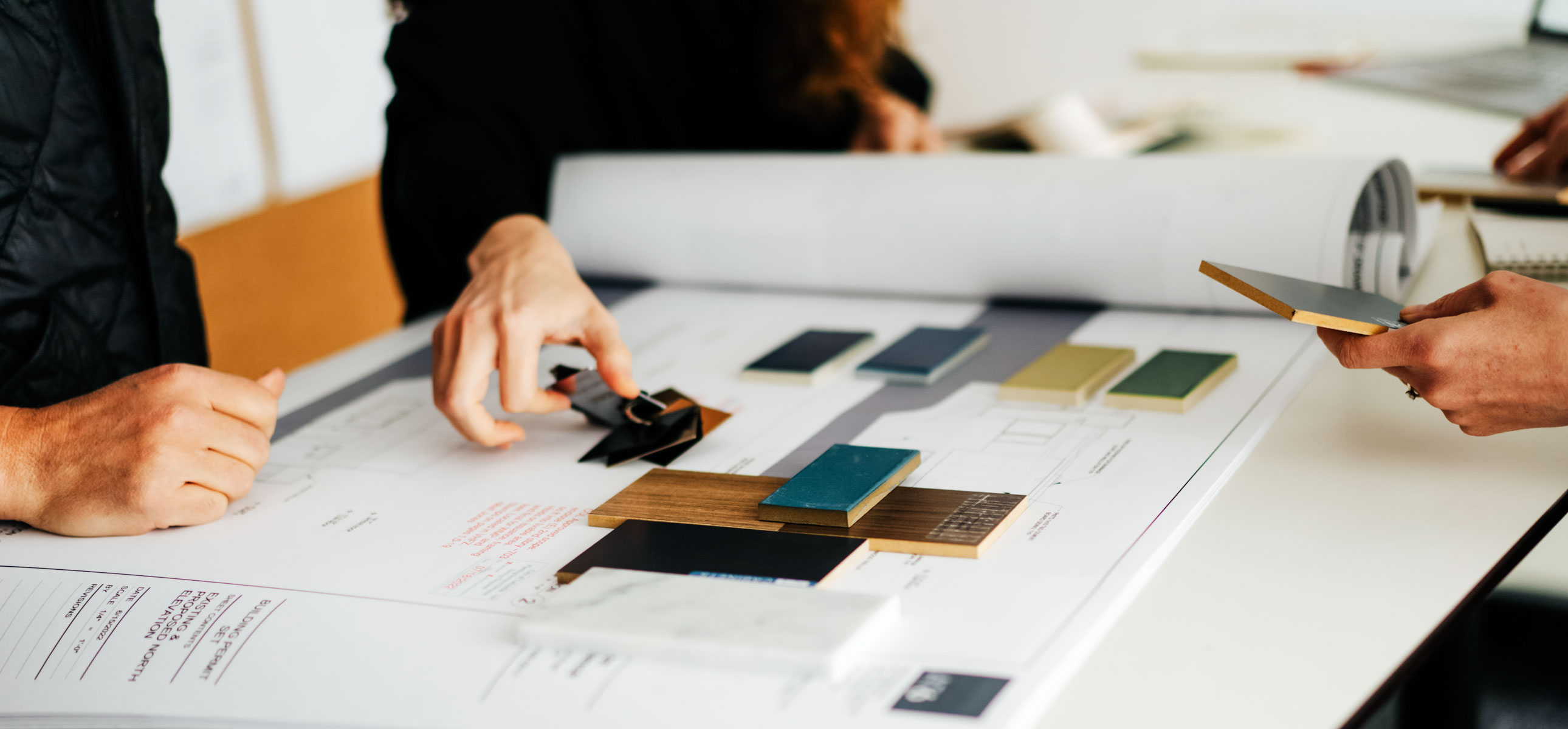 hands organizing interior samples on table