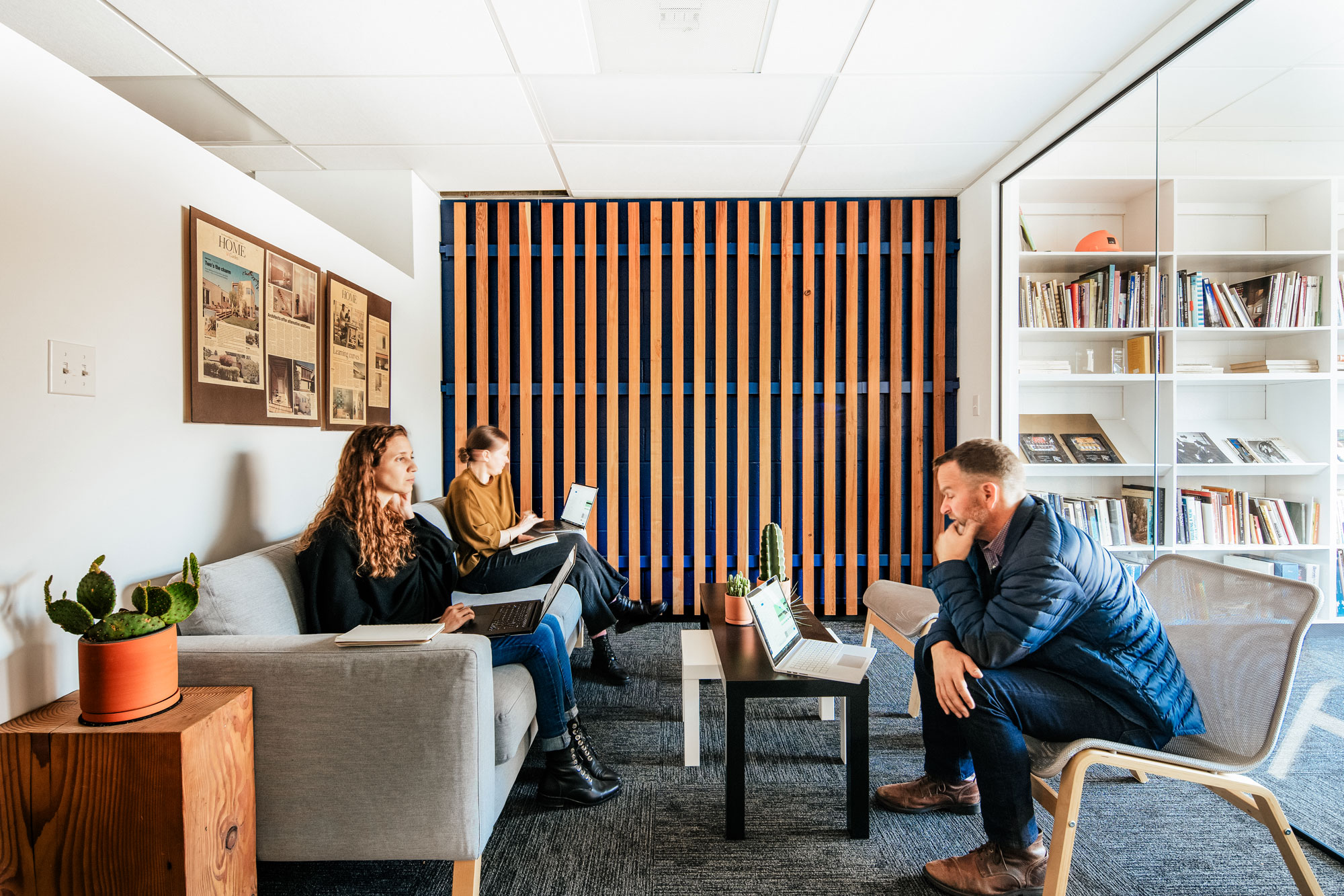 three employees collaborating in office lounge