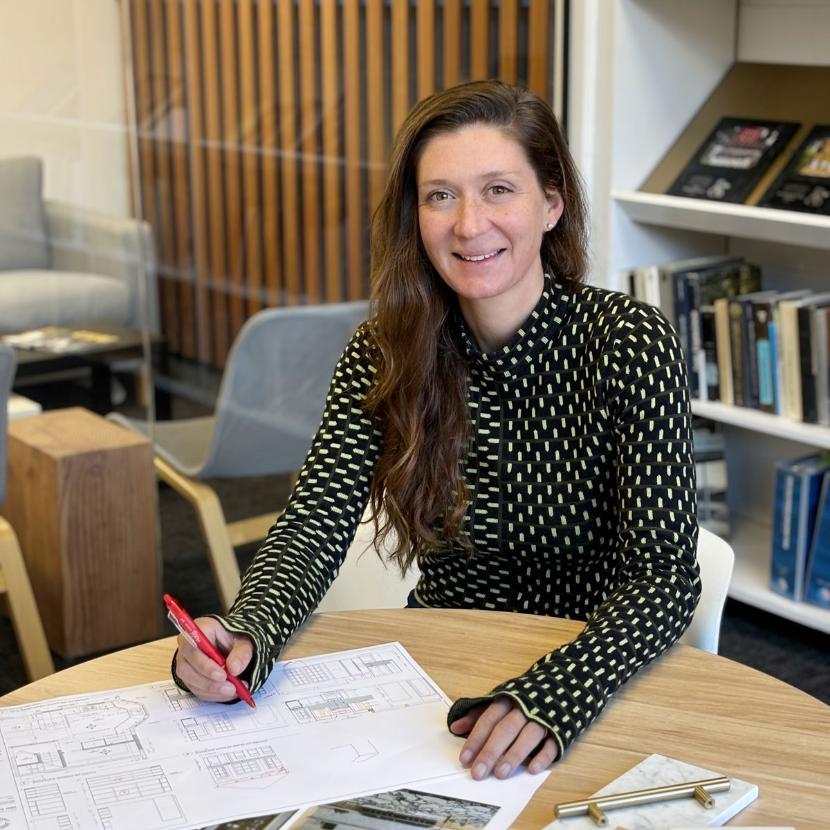 Lauren Martino working in office at round desk