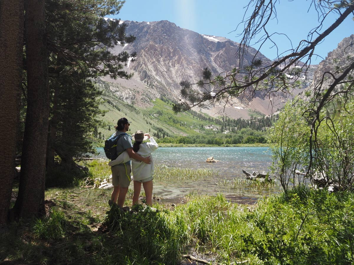 Vanessa Leedy with friend on hike in mountains with lake