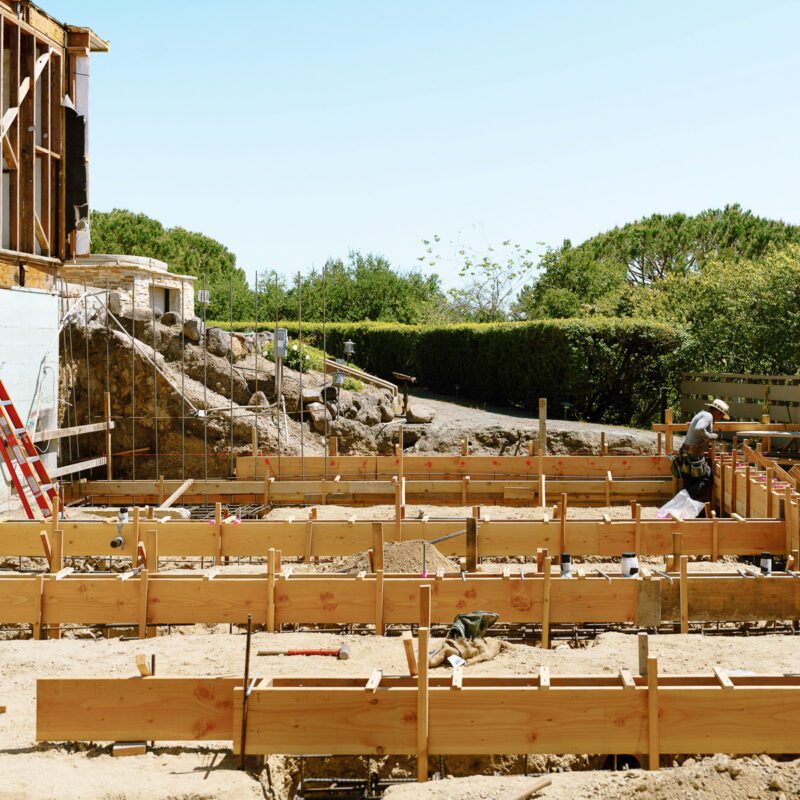 Contractor on construction site with hat and tools