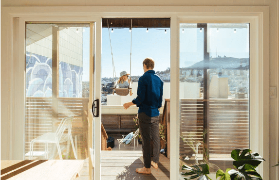 In San Francisco, a client who remodeled his home swings his daughter on their new deck. 