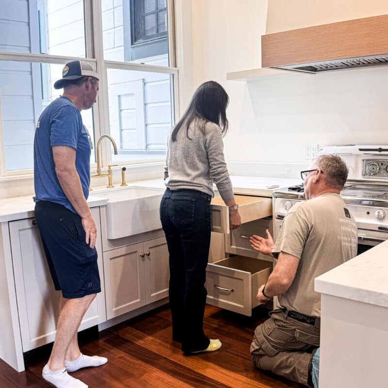 AT6 Architecture + Design Build client working with project manager to understand how her new kitchen drawers operate in her modern Castro neighborhood home in San Francisco. Remodel completed by AT6 Architecture + Design Build